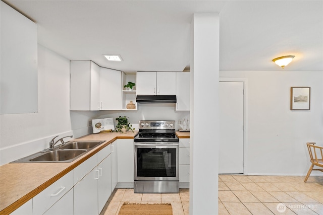 6719 46th Ave S, Seattle, WA 98118 - kitchen with stainless steel range with electric cooktop, under cabinet range hood, white cabinetry, open shelves, and light tile patterned floors