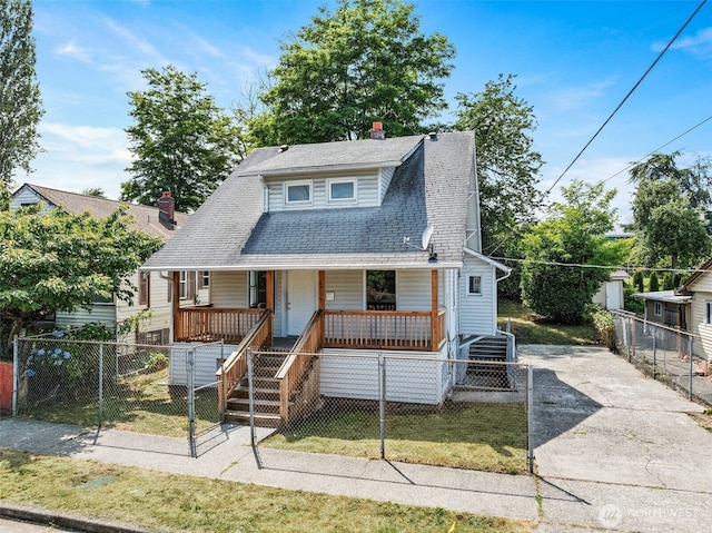 6719 46th Ave S, Seattle, WA 98118 - view of front of property featuring a porch, stairway, a shingled roof, and a fenced front yard