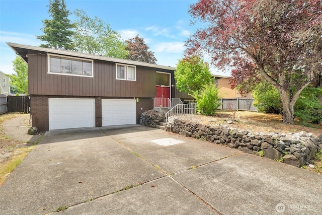 1102 Tule Lake Rd S, Tacoma, WA 98444 - view of front of home featuring an attached garage, concrete driveway, and brick siding