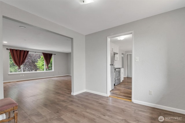 1102 Tule Lake Rd S, Tacoma, WA 98444 - spare room featuring wood finished floors and baseboards