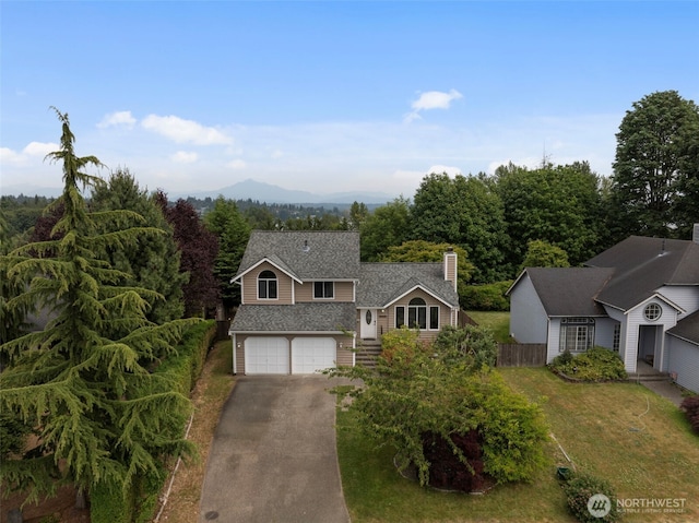 1521 90th Dr NE, Lake Stevens, WA 98258 - view of front of property with asphalt driveway, an attached garage, a chimney, and roof with shingles