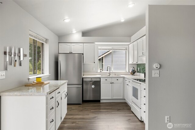 1521 90th Dr NE, Lake Stevens, WA 98258 - kitchen featuring stainless steel appliances, vaulted ceiling, dark wood-style flooring, white cabinets, and recessed lighting