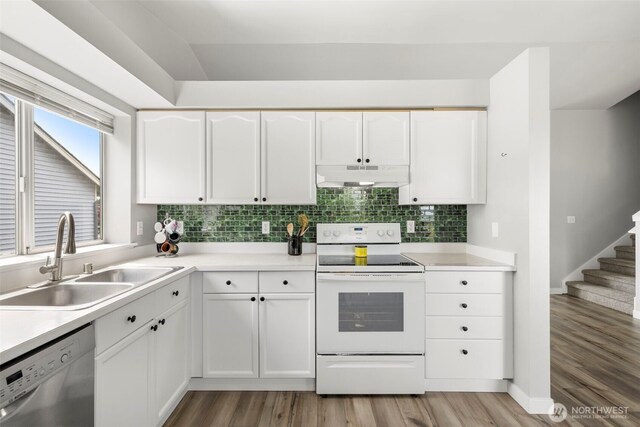 1521 90th Dr NE, Lake Stevens, WA 98258 - kitchen featuring stainless steel dishwasher, under cabinet range hood, white range with electric stovetop, light wood-type flooring, and white cabinetry