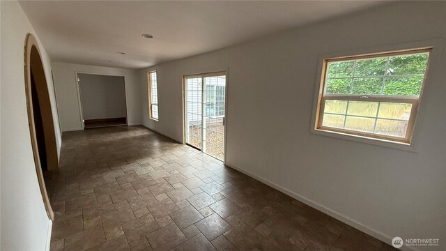 57 Covered Bridge Rd, Grays River, WA 98621 - unfurnished room featuring stone tile floors and arched walkways