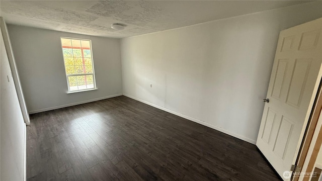 57 Covered Bridge Rd, Grays River, WA 98621 - unfurnished room with dark wood-style flooring and a textured ceiling
