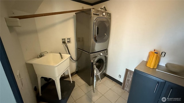 57 Covered Bridge Rd, Grays River, WA 98621 - laundry room featuring estacked washer and dryer and light tile patterned floors