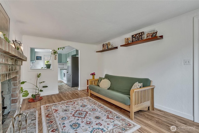 1400 Baby Doll Rd SE, Port Orchard, WA 98366 - sitting room featuring light wood-style flooring and a fireplace with raised hearth