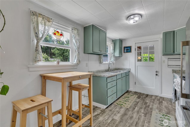 1400 Baby Doll Rd SE, Port Orchard, WA 98366 - kitchen with green cabinets, light countertops, plenty of natural light, and light wood-style floors