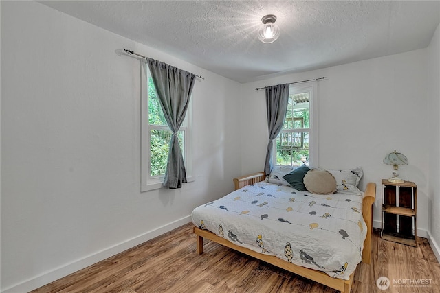 1400 Baby Doll Rd SE, Port Orchard, WA 98366 - bedroom featuring radiator, light wood-type flooring, and a textured ceiling
