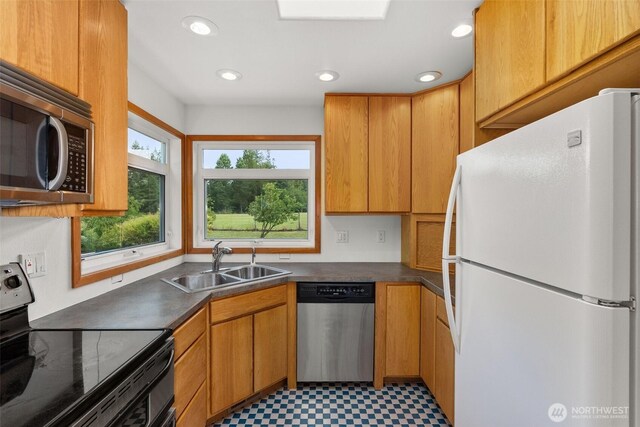 107 Gilbert Rd N, Onalaska, WA 98570 - kitchen with appliances with stainless steel finishes, light floors, dark countertops, and recessed lighting