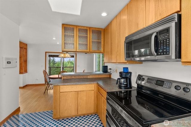 107 Gilbert Rd N, Onalaska, WA 98570 - kitchen featuring stainless steel appliances, a peninsula, glass insert cabinets, recessed lighting, and dark countertops
