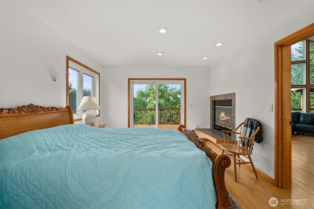 107 Gilbert Rd N, Onalaska, WA 98570 - bedroom with wood finished floors, a tiled fireplace, and recessed lighting