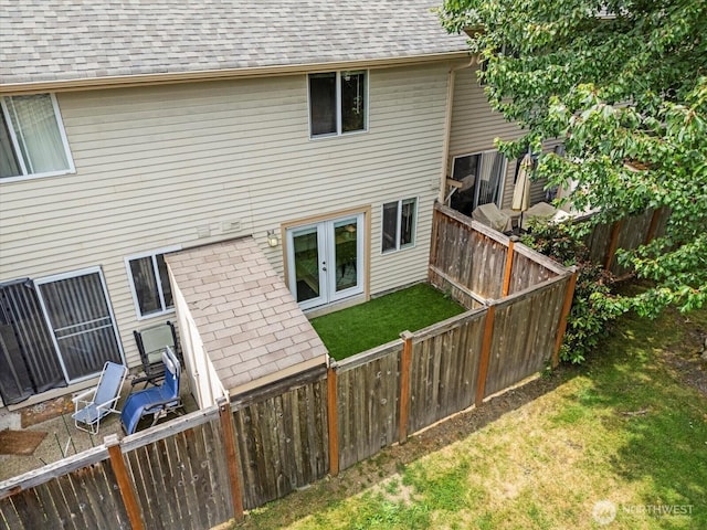 115 124th St SE Unit G5, Everett, WA 98208 - rear view of property with french doors, a shingled roof, and a fenced backyard