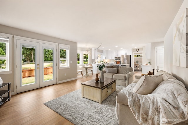 1514 232nd Pl SW, Bothell, WA 98021 - living room with french doors, light wood-type flooring, recessed lighting, and a chandelier