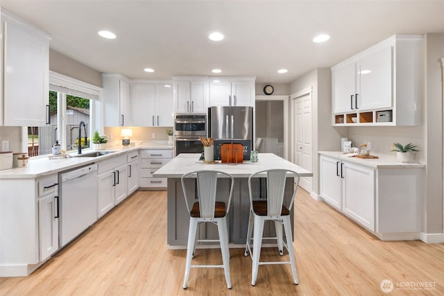 1514 232nd Pl SW, Bothell, WA 98021 - kitchen with stainless steel appliances, a kitchen island, white cabinetry, and recessed lighting
