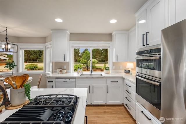 1514 232nd Pl SW, Bothell, WA 98021 - kitchen featuring stainless steel appliances, plenty of natural light, white cabinetry, light stone countertops, and recessed lighting