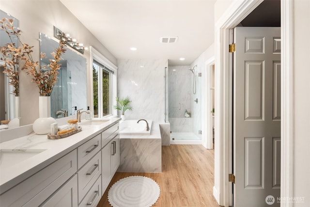 1514 232nd Pl SW, Bothell, WA 98021 - full bathroom featuring a bath, double vanity, a marble finish shower, and wood finished floors