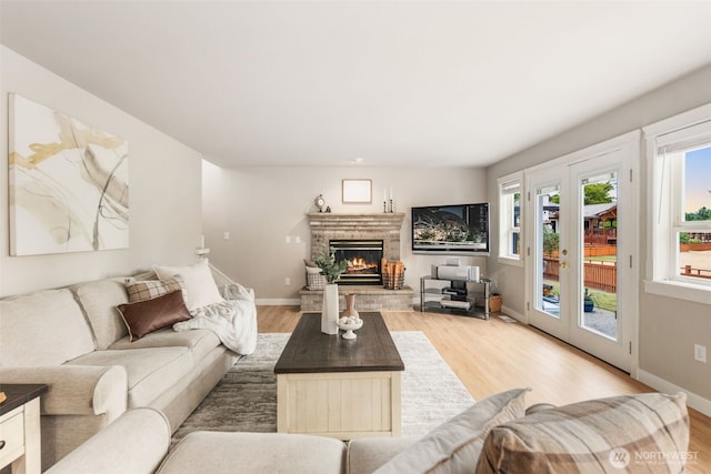 1514 232nd Pl SW, Bothell, WA 98021 - living room featuring light wood-style floors, a fireplace, and french doors