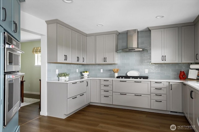 179 Perry Dr, Coupeville, WA 98239 - kitchen featuring wall chimney range hood, gray cabinets, light countertops, decorative backsplash, and recessed lighting