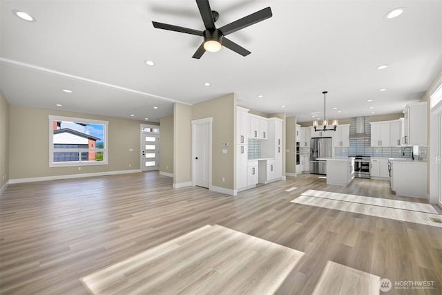 5513 Presley Ln, Ferndale, WA 98248 - unfurnished living room with a chandelier, ceiling fan, light wood-style floors, and recessed lighting