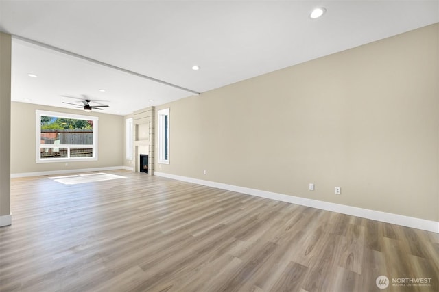 5513 Presley Ln, Ferndale, WA 98248 - unfurnished living room featuring light wood-style floors, ceiling fan, a large fireplace, and recessed lighting
