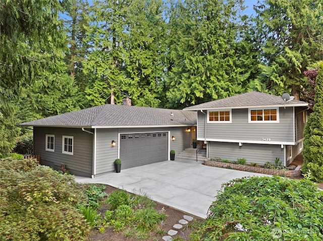 3420 210th Pl NE, Sammamish, WA 98074 - tri-level home featuring a chimney, concrete driveway, and roof with shingles