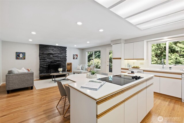 3420 210th Pl NE, Sammamish, WA 98074 - kitchen featuring black electric stovetop, open floor plan, light wood-style floors, recessed lighting, and a kitchen island