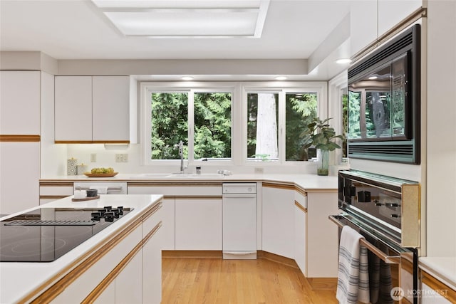 3420 210th Pl NE, Sammamish, WA 98074 - kitchen featuring black appliances, white cabinetry, light countertops, and light wood finished floors