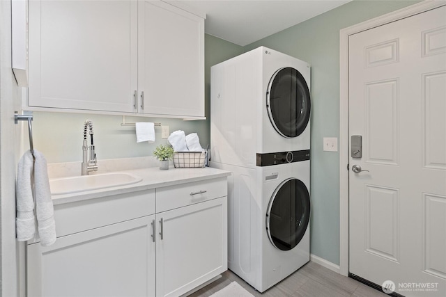 3420 210th Pl NE, Sammamish, WA 98074 - laundry area featuring stacked washer and clothes dryer and cabinet space