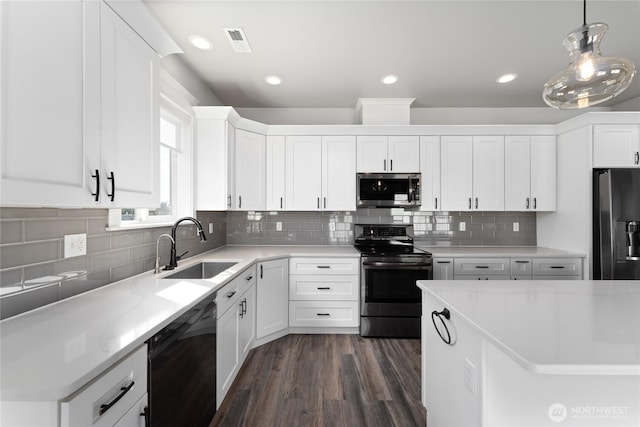 1300 W Marina Dr Unit 33, Moses Lake, WA 98837 - kitchen with appliances with stainless steel finishes, white cabinetry, light countertops, dark wood-type flooring, and decorative light fixtures