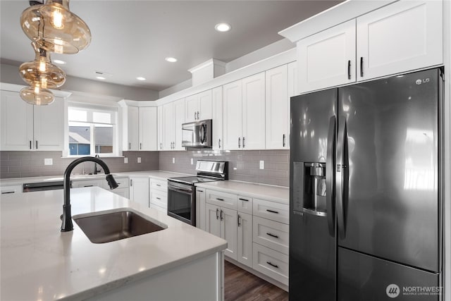 1300 W Marina Dr Unit 33, Moses Lake, WA 98837 - kitchen featuring stainless steel appliances, decorative backsplash, white cabinetry, hanging light fixtures, and recessed lighting