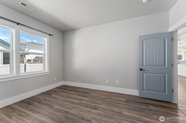 1300 W Marina Dr Unit 33, Moses Lake, WA 98837 - unfurnished room featuring dark wood-style flooring and baseboards
