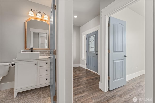 1300 W Marina Dr Unit 33, Moses Lake, WA 98837 - bathroom featuring vanity, wood finished floors, decorative backsplash, and recessed lighting