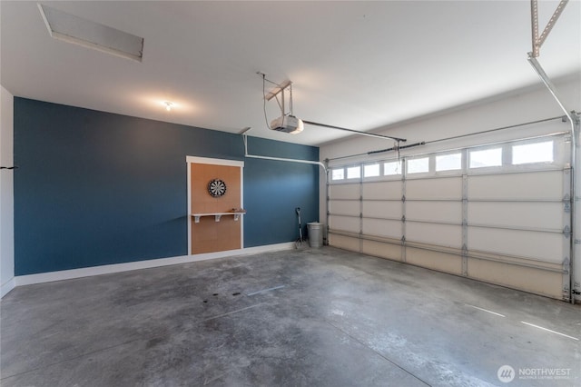 1300 W Marina Dr Unit 33, Moses Lake, WA 98837 - garage featuring a garage door opener and baseboards