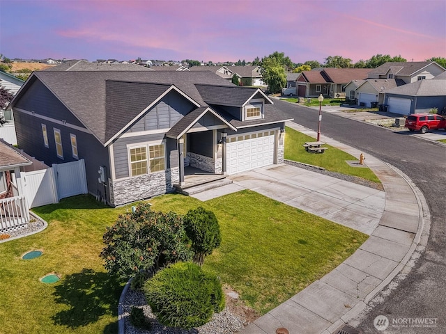 1300 W Marina Dr Unit 33, Moses Lake, WA 98837 - view of front of home with stone siding, a residential view, driveway, and a shingled roof