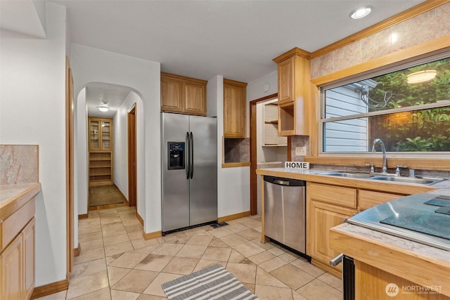 123 Scenic View Dr, Longview, WA 98632 - kitchen featuring stainless steel appliances, arched walkways, light countertops, and light tile patterned flooring