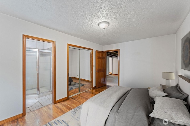 123 Scenic View Dr, Longview, WA 98632 - bedroom featuring light wood finished floors, a closet, and a textured ceiling