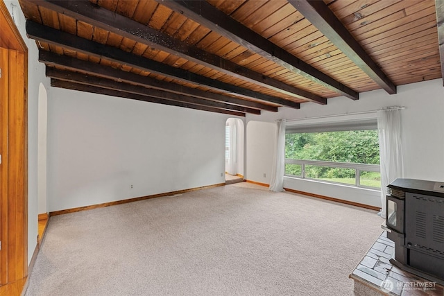 123 Scenic View Dr, Longview, WA 98632 - unfurnished living room with a wood stove, carpet, arched walkways, and a wooden ceiling with exposed beams