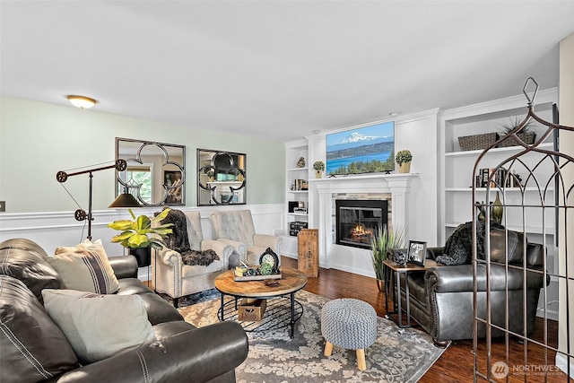 2313 S Cedar St Unit 107, Tacoma, WA 98405 - living area featuring built in shelves, wood finished floors, and a glass covered fireplace
