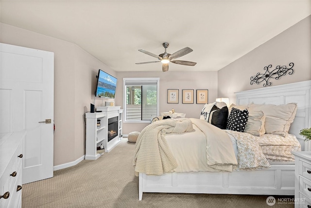 2313 S Cedar St Unit 107, Tacoma, WA 98405 - bedroom featuring light colored carpet, a lit fireplace, and a ceiling fan