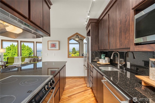 3519 N Union Ave Unit 2, Tacoma, WA 98407 - kitchen featuring appliances with stainless steel finishes, under cabinet range hood, plenty of natural light, and backsplash