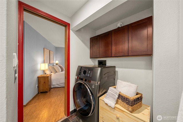 3519 N Union Ave Unit 2, Tacoma, WA 98407 - washroom with washer / dryer, cabinet space, and wood finished floors