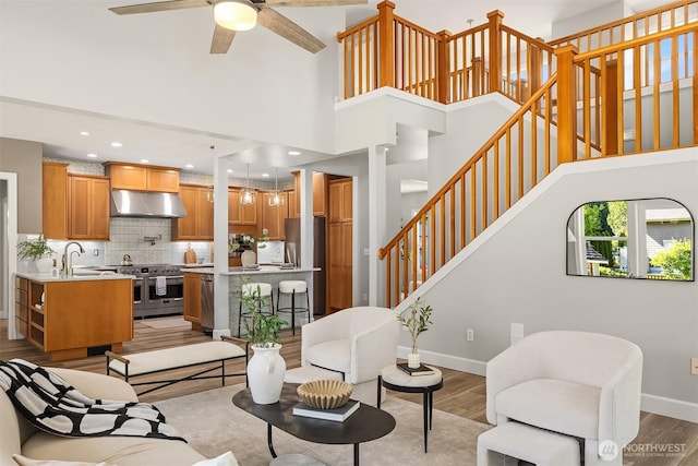 32701 SE 43rd St, Fall City, WA 98024 - living area featuring stairs, a towering ceiling, light wood-type flooring, a ceiling fan, and recessed lighting