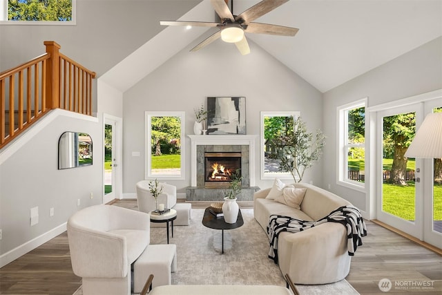 32701 SE 43rd St, Fall City, WA 98024 - living room with wood finished floors, high vaulted ceiling, healthy amount of natural light, a ceiling fan, and a premium fireplace
