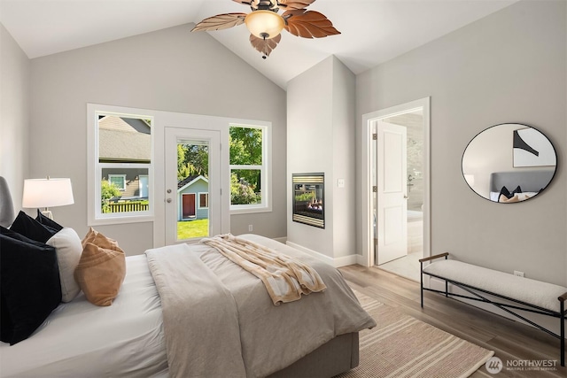32701 SE 43rd St, Fall City, WA 98024 - bedroom featuring access to exterior, light wood finished floors, lofted ceiling, a glass covered fireplace, and ensuite bathroom