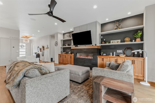 18500 NE 79th, Vancouver, WA 98682 - living room with a tile fireplace, a ceiling fan, built in shelves, recessed lighting, and light wood-style flooring