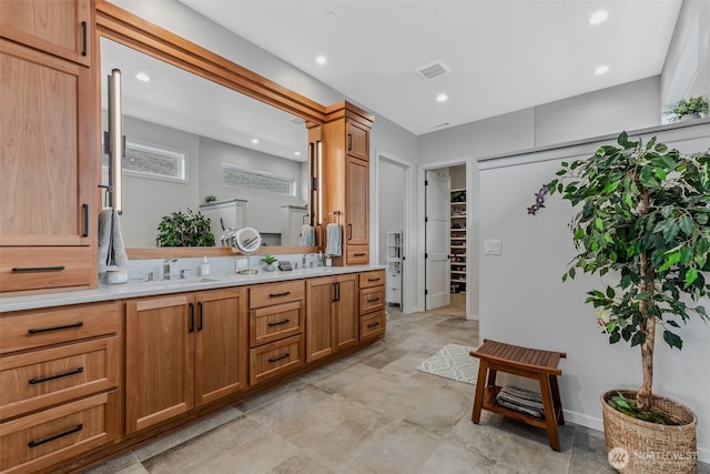 18500 NE 79th, Vancouver, WA 98682 - bathroom featuring double vanity, recessed lighting, stone finish floors, and a spacious closet