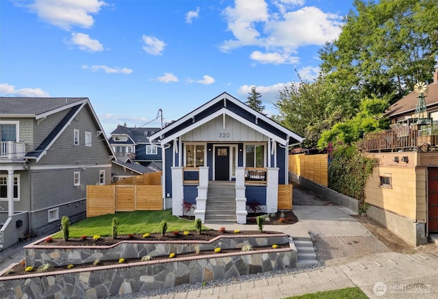 320 NW 51st St Unit A, Seattle, WA 98107 - view of front facade featuring board and batten siding, a porch, and stairway