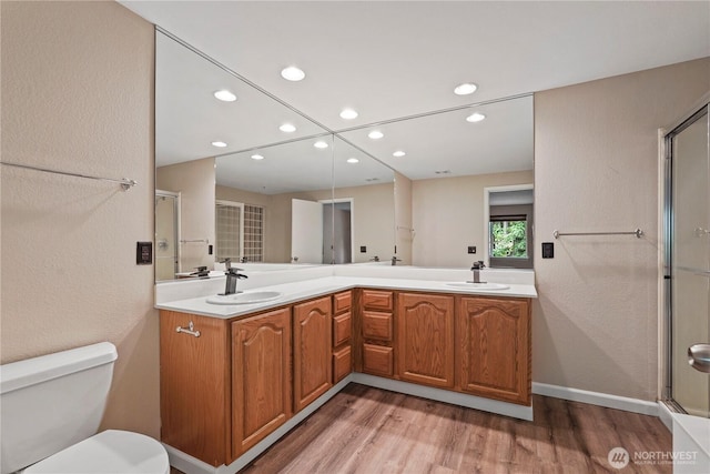 9910 Fairview Lake Rd SW, Port Orchard, WA 98367 - full bath featuring recessed lighting, wood finished floors, double vanity, and an enclosed shower