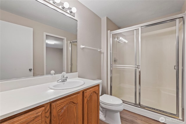 9910 Fairview Lake Rd SW, Port Orchard, WA 98367 - full bathroom with vanity, a stall shower, and wood finished floors
